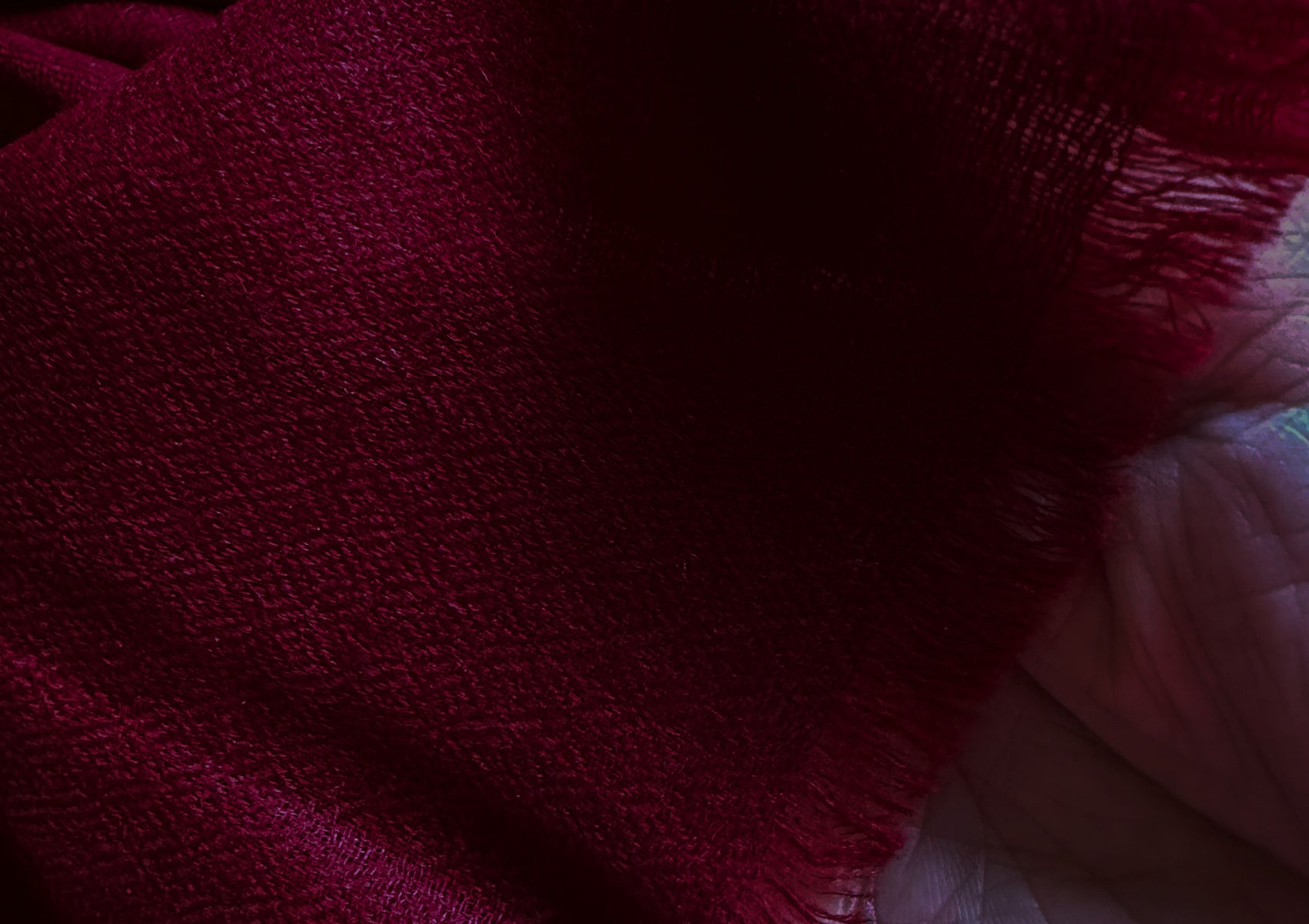 Close-up view of a bodhi pashmina meditation shawl in burgundy, showcasing the delicate weave and soft texture.