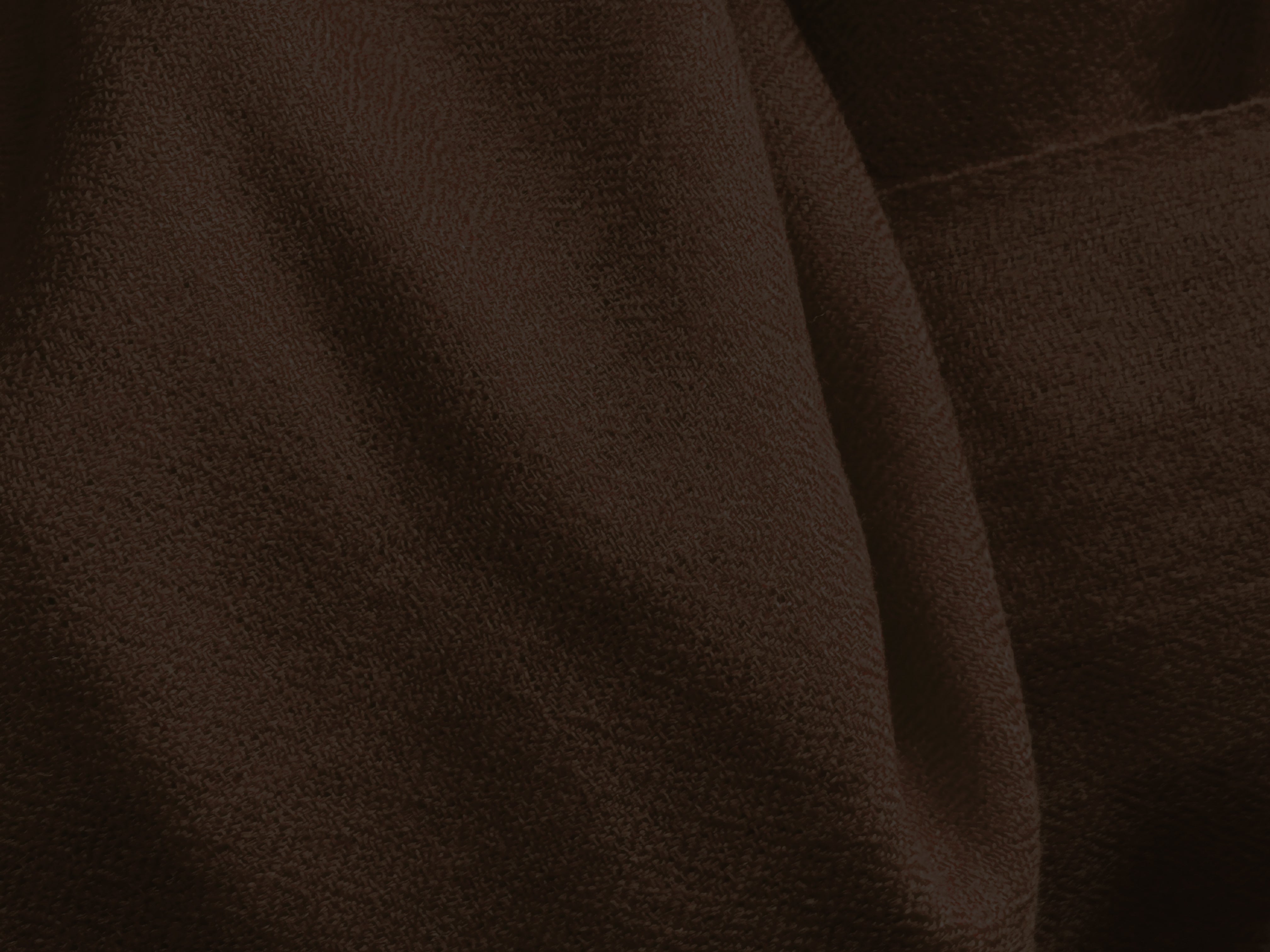 Close-up texture of a brown meditation shawl, highlighting the softness and fabric weave.