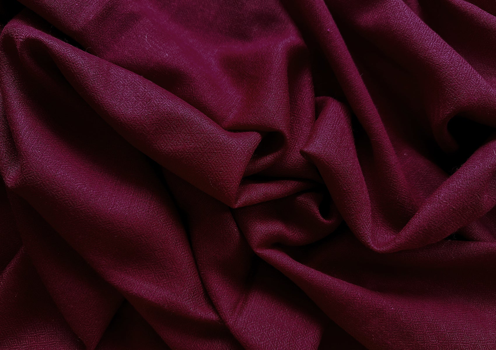 Soft burgundy pashmina shawl draped elegantly, highlighting its rich texture and deep color, ideal for meditation.