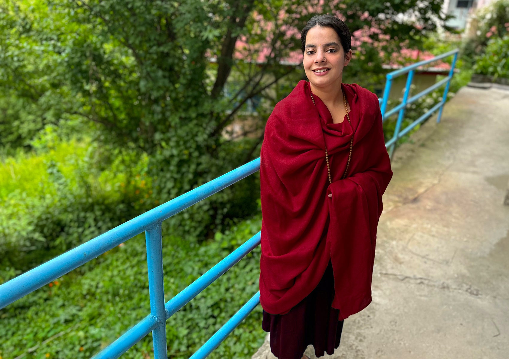 Close-up of a fine merino wool shawl in rich red, designed for meditation and warmth.