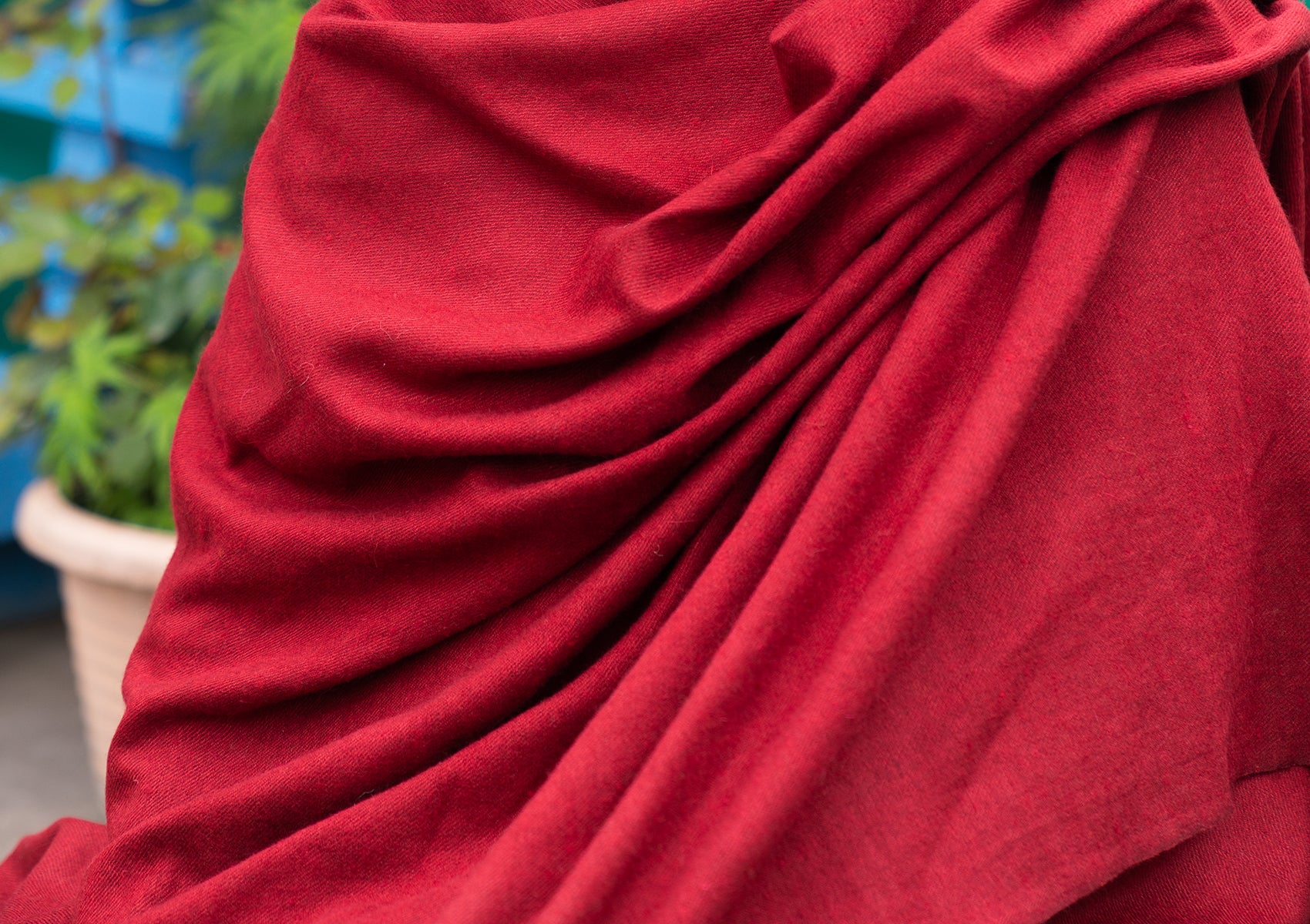 Detailed view of a handmade yoga shawl in a natural burgundy color.