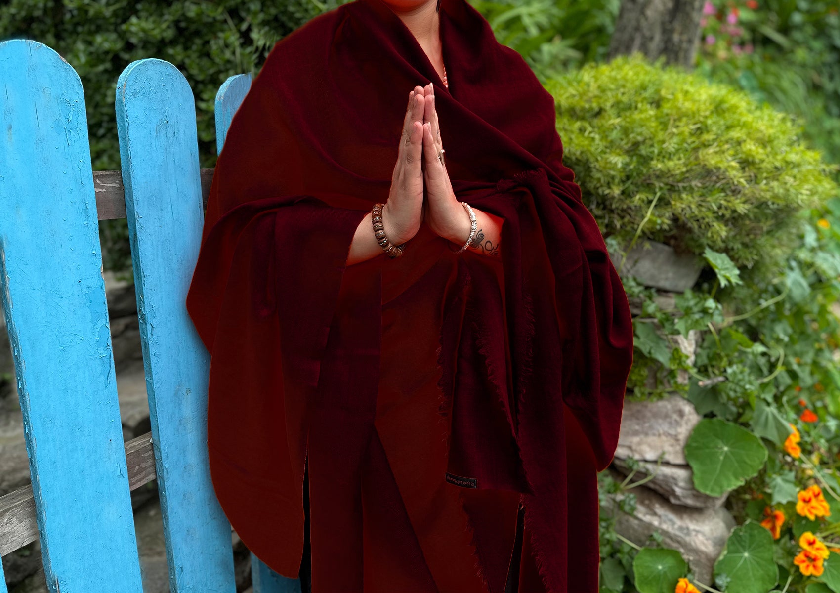 Luxurious burgundy shawl draped elegantly, capturing the richness and softness of the fabric.