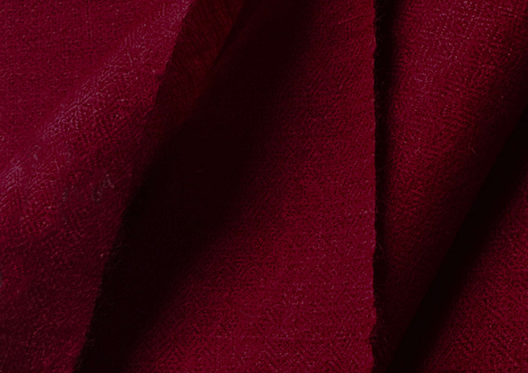 Luxurious red pashmina shawl spread out, showing the soft and high-quality fabric.