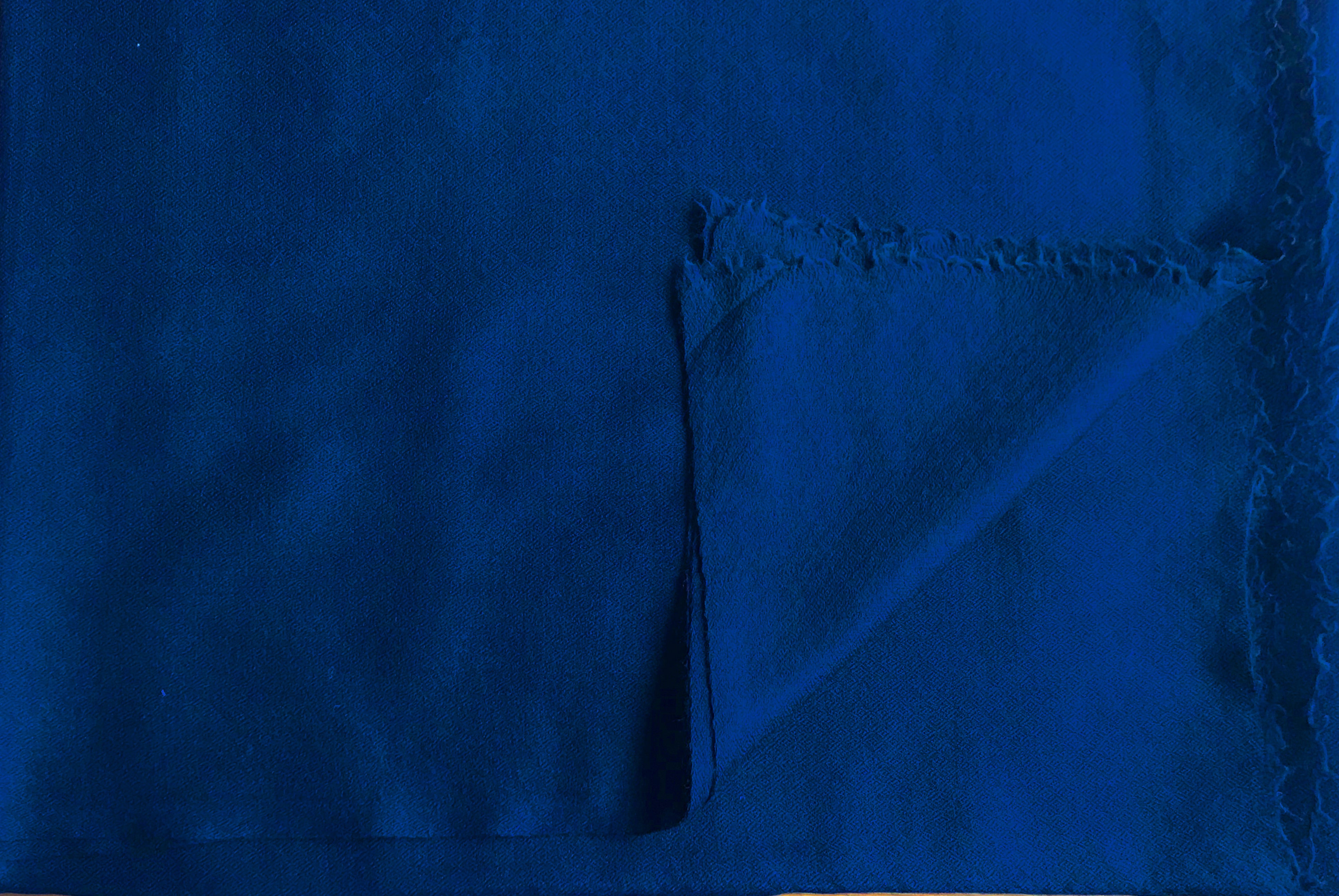 Close-up of a royal blue meditation shawl, showcasing its soft texture and neatly finished edges.