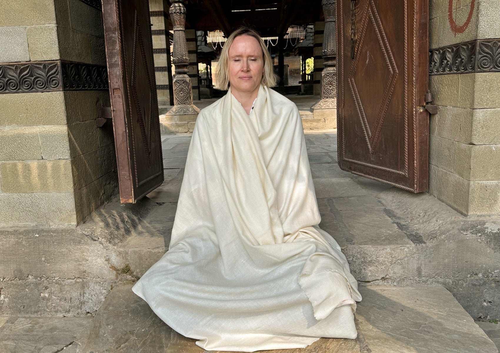 Full view of a large cream angora shawl draped elegantly.