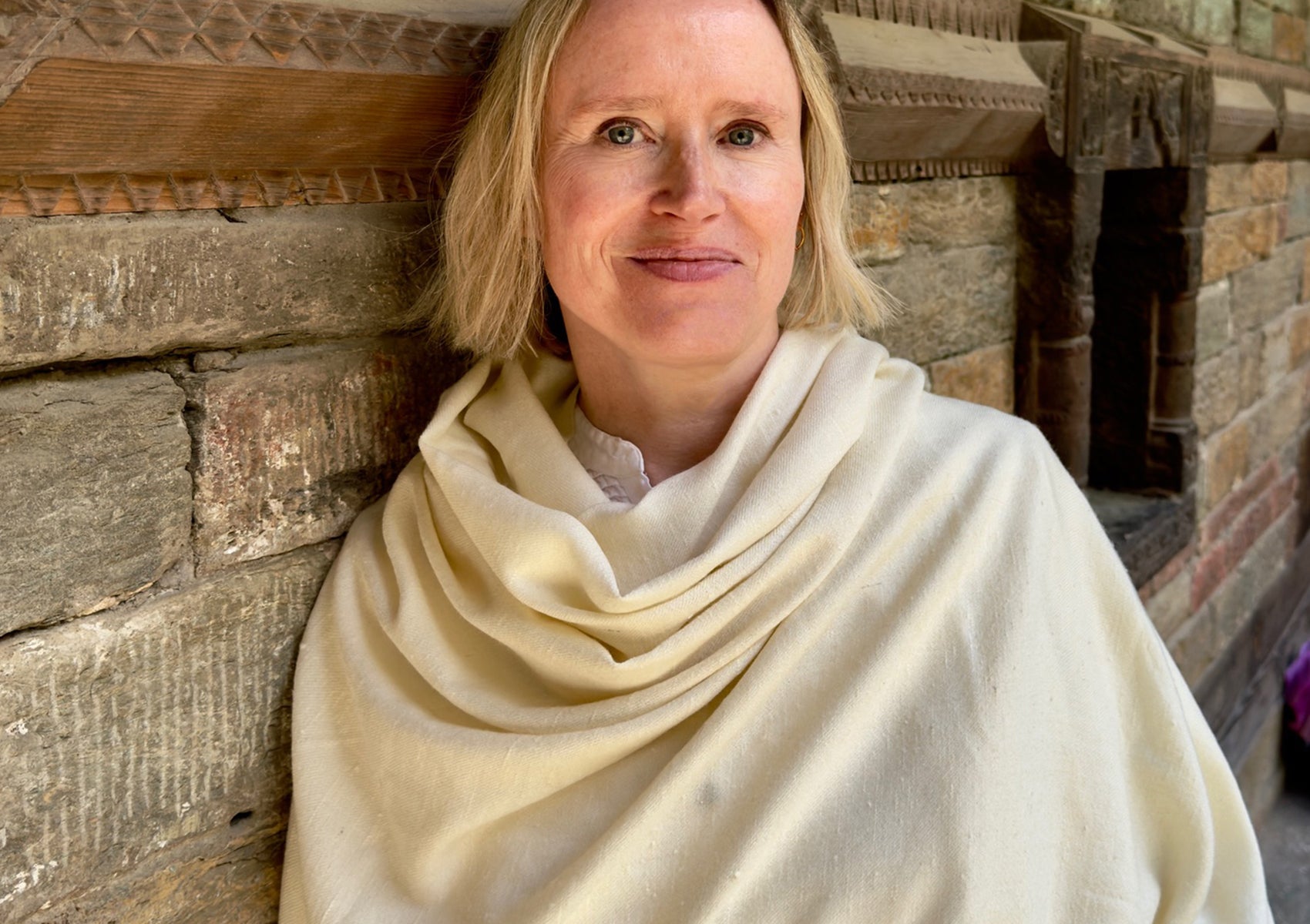 Close-up of a large angora prayer shawl in a natural cream color.