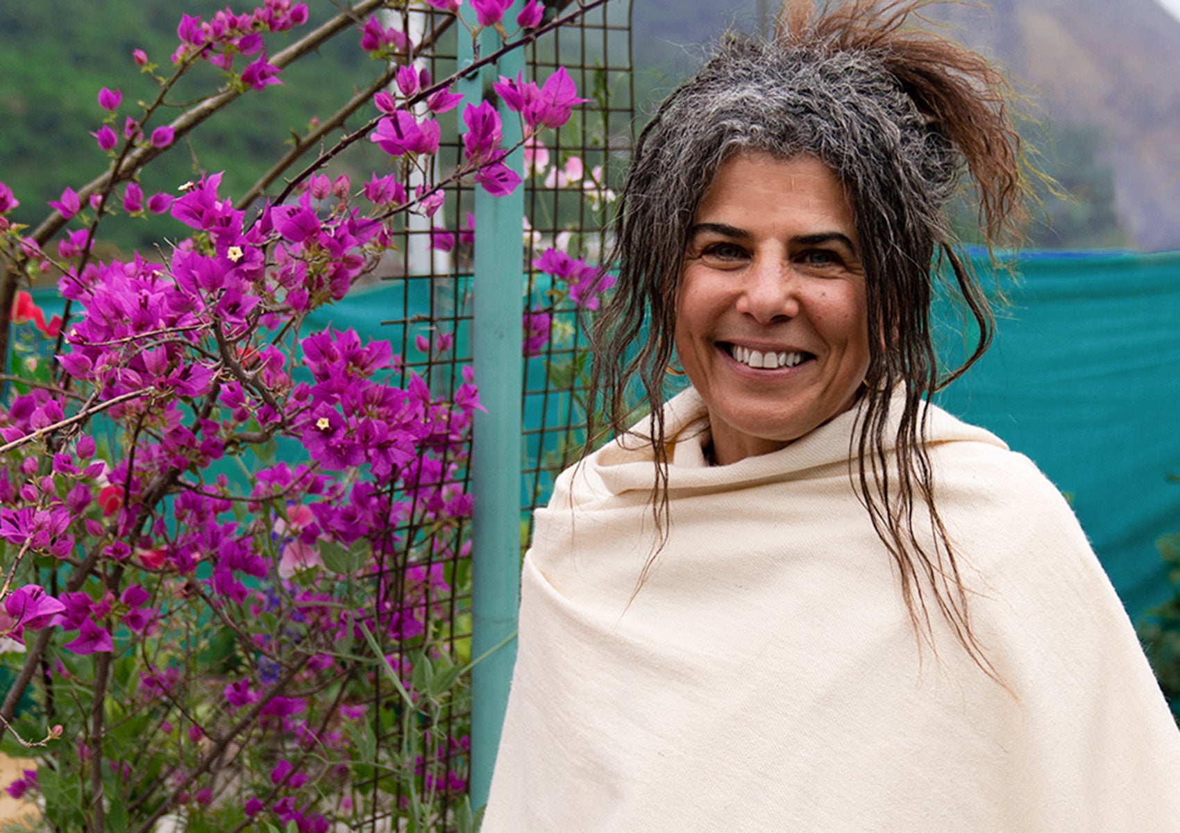 Woman wearing a silk meditation shawl in cream, with a serene background.