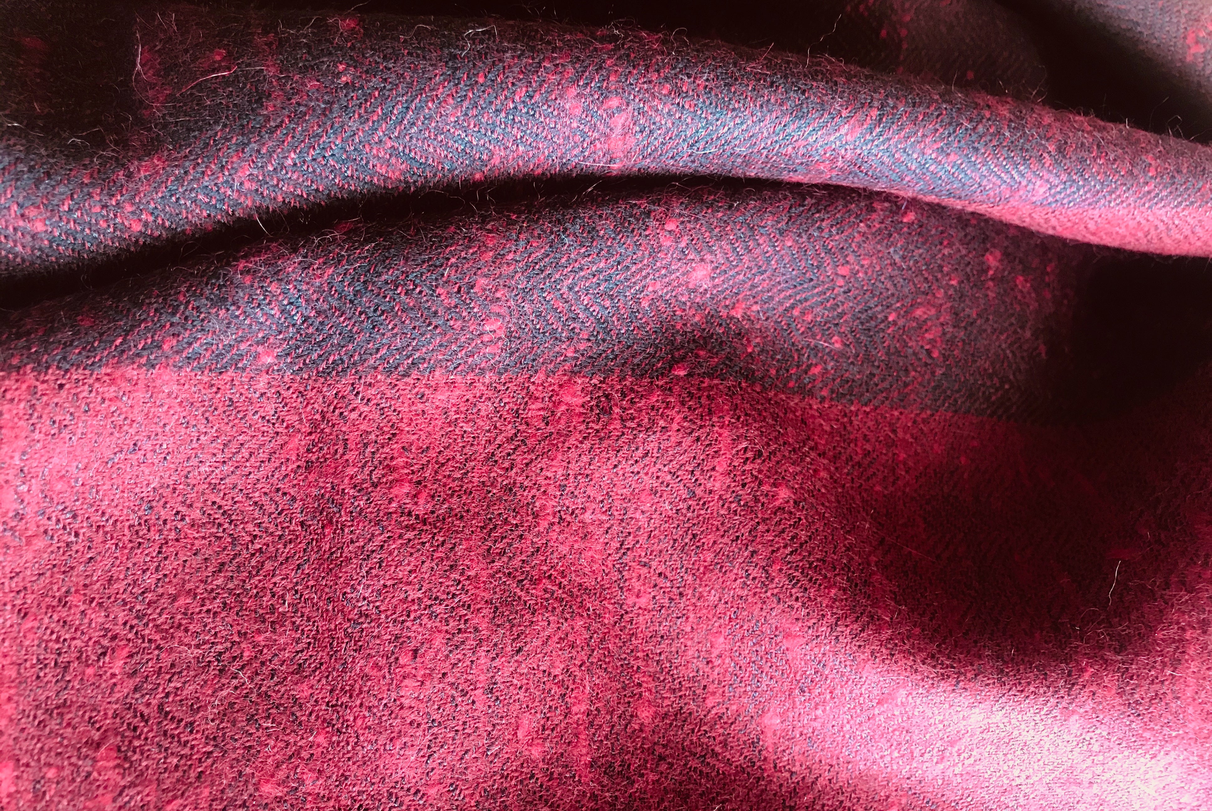 Folded burgundy shawl, focusing on its warm and cozy appearance.