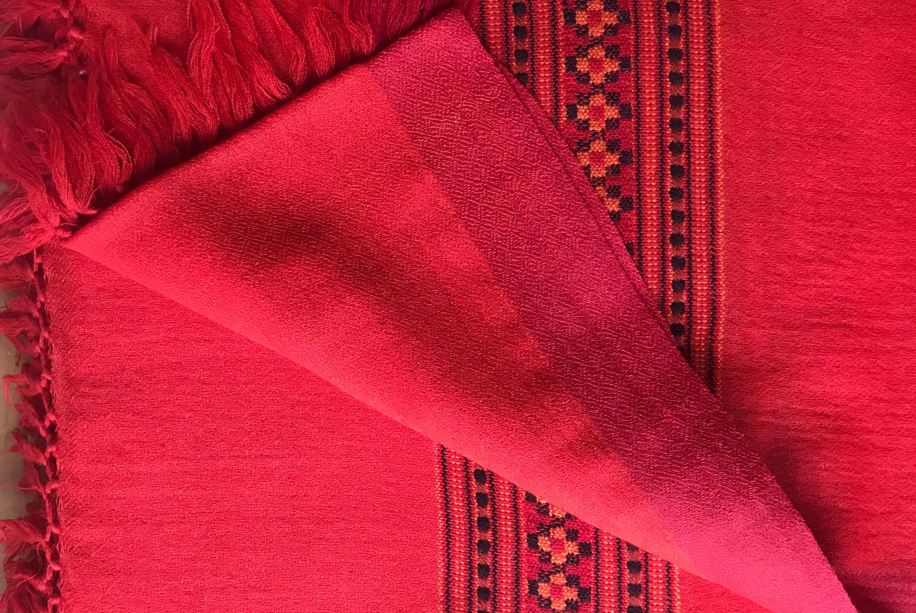 Deep red Karuna meditation shawl with ethnic border design, suitable for meditation.