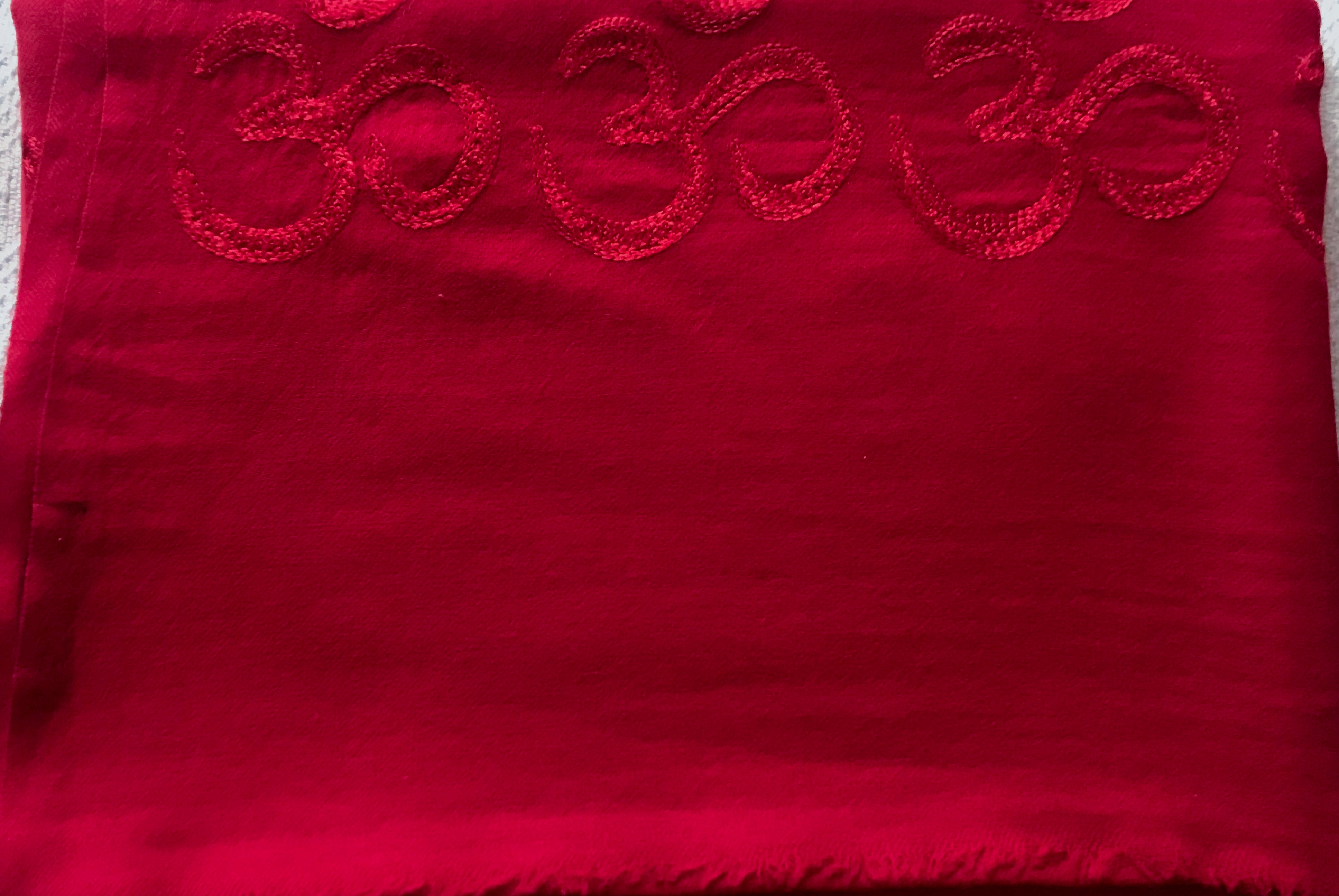 Deep red shawl embroidered with the Om symbol for meditation.