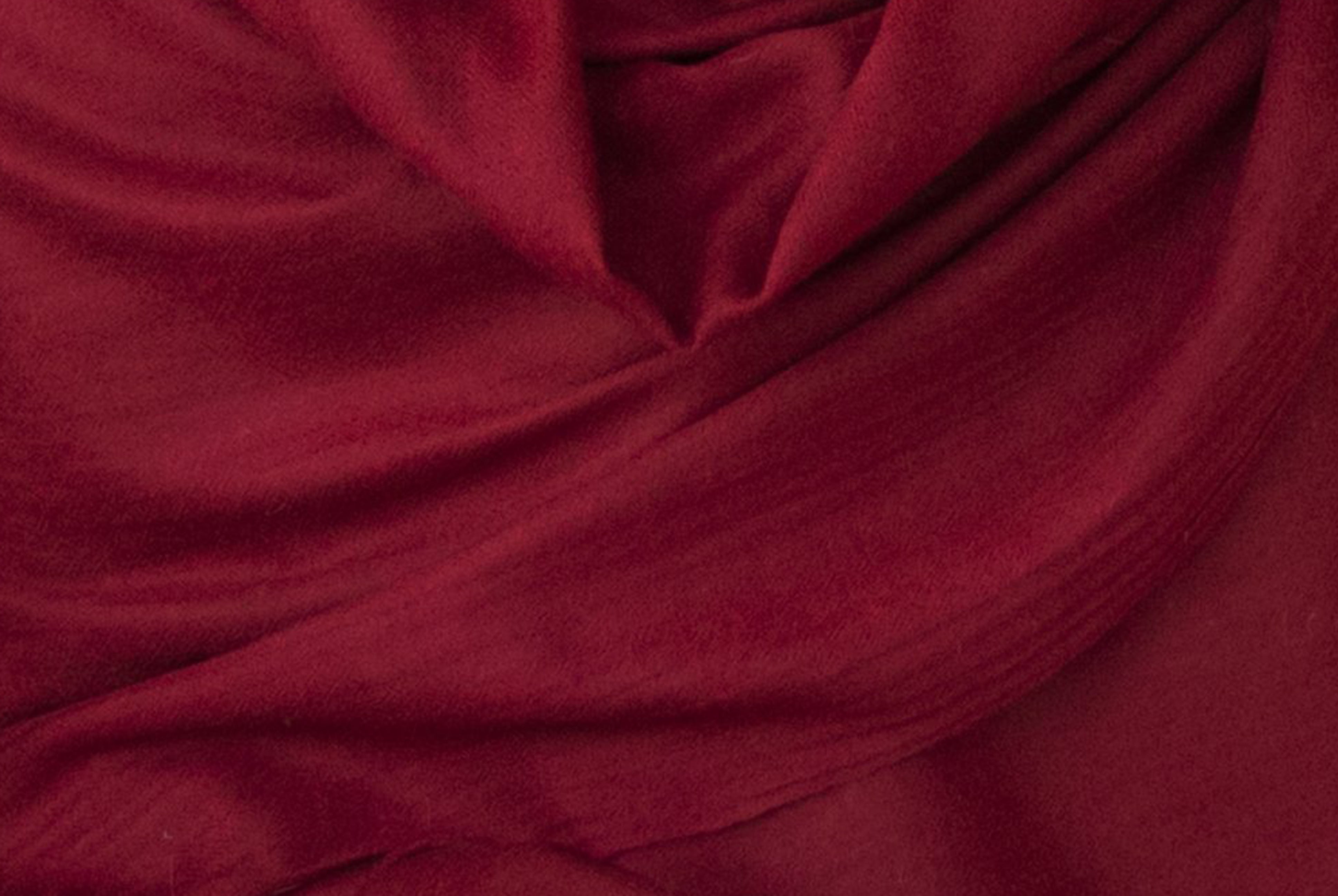 Close-up of the soft and luxurious texture of a burgundy Rasana Angora wool shawl, showcasing its fine craftsmanship and warmth.