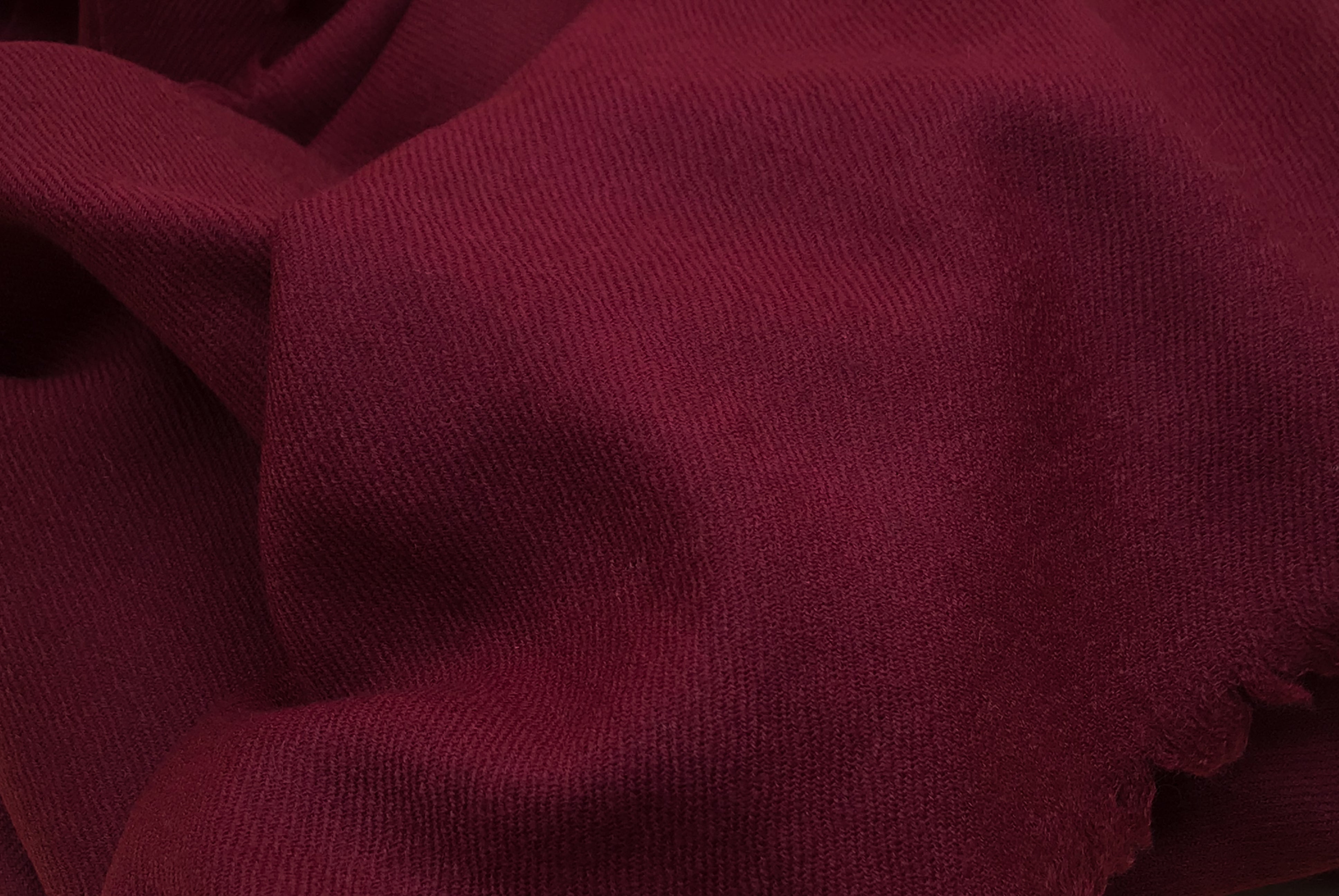 Close-up texture of the Shambhala burgundy wool shawl, showcasing its premium fabric and soft weave, designed for warmth and comfort.